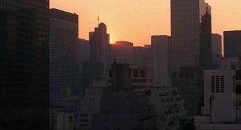 Movie still from “Black Caesar” (1973), directed by Larry Cohen – The sun is setting over a large city; Extreme Wide shot, High angle