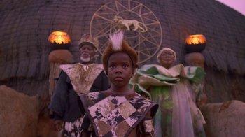 Movie still from “Black Is King” (2020), directed by Julian Klincewicz – A group of people dressed up in costumes; Medium shot, Low angle