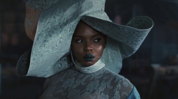 Movie still from “Black Is King” (2020), directed by Julian Klincewicz – A woman in a blue dress and a white hat; Close Up shot, Low angle