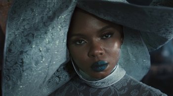 Movie still from “Black Is King” (2020), directed by Julian Klincewicz – A person wearing a blue lipstick; Close Up shot, Low angle