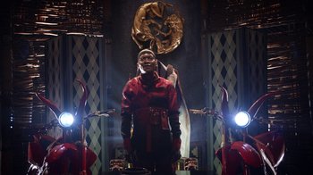 Movie still from “Black Is King” (2020), directed by Julian Klincewicz – A man standing in front of a mirror in a room; Medium shot, Low angle