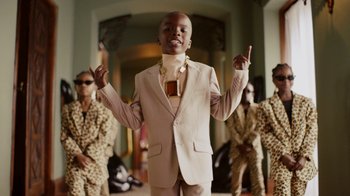 Movie still from “Black Is King” (2020), directed by Julian Klincewicz – A young man in a suit and a tie; Medium shot, Low angle