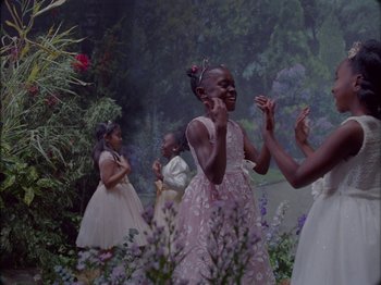 Movie still from “Black Is King” (2020), directed by Julian Klincewicz – A group of young girls in a garden; Medium shot, High angle