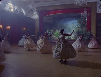 Movie still from “Black Is King” (2020), directed by Julian Klincewicz – A group of women in white dresses dancing in a room; Extreme Wide shot, High angle