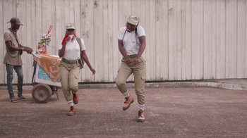 Movie still from “Black Is King” (2020), directed by Julian Klincewicz – A couple of people that are jumping in the air; Wide shot, Low angle