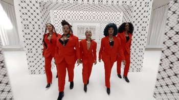 Movie still from “Black Is King” (2020), directed by Julian Klincewicz – A group of women dressed in red standing next to each other; Extreme Wide shot, Low angle