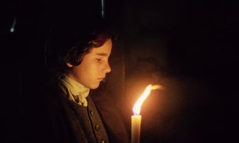 Movie still from “Black Jack” (1979), directed by Ken Loach – A young man holding a candle in a dark room; Close Up shot, Low angle