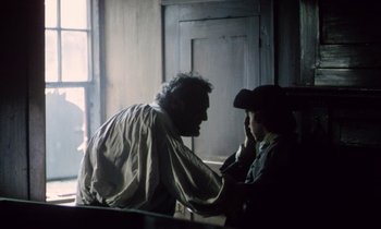 Movie still from “Black Jack” (1979), directed by Ken Loach – A man and a woman sitting in front of each other; Medium shot, Over the shoulder angle