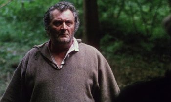 Movie still from “Black Jack” (1979), directed by Ken Loach – A person wearing a sweater near a forest; Close Up shot, Low angle