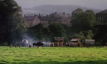 Movie still from “Black Jack” (1979), directed by Ken Loach – A group of people standing in a field with horses; Extreme Wide shot, High angle