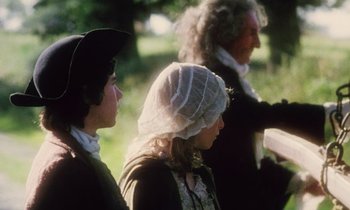 Movie still from “Black Jack” (1979), directed by Ken Loach – A group of people standing next to each other on a field; Medium shot, Over the shoulder angle