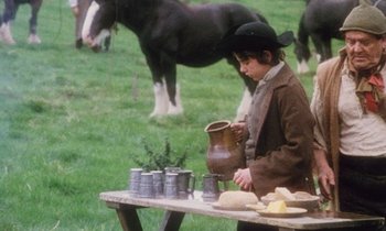 Movie still from “Black Jack” (1979), directed by Ken Loach – A young boy is standing in front of a table with pots on it; Medium shot, High angle