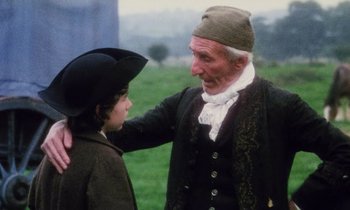 Movie still from “Black Jack” (1979), directed by Ken Loach – An old man and a young boy in a field; Medium shot, Over the shoulder angle