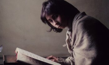 Movie still from “Black Jack” (1979), directed by Ken Loach – A young girl is looking at a piece of paper on a table; Close Up shot, High angle