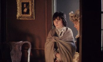 Movie still from “Black Jack” (1979), directed by Ken Loach – A woman wrapped in a blanket next to another woman in a chair; Medium shot, Over the shoulder angle