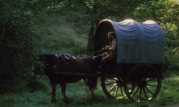 Movie still from “Black Jack” (1979), directed by Ken Loach – A man sitting in the back of a horse drawn carriage; Wide shot, High angle