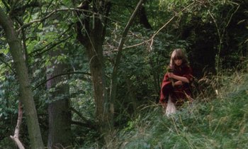 Movie still from “Black Jack” (1979), directed by Ken Loach – A young girl in a red cape in the woods; Wide shot, High angle