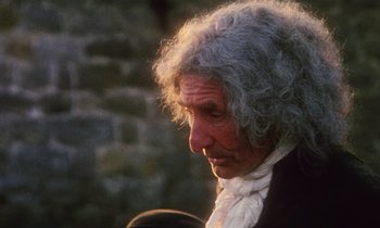 Movie still from “Black Jack” (1979), directed by Ken Loach – An older man with grey curly hair wearing a black jacket; Close Up shot, Over the shoulder angle