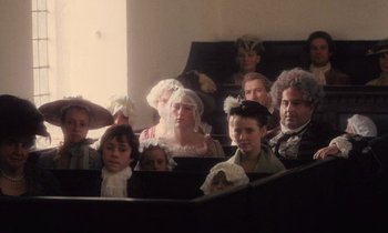 Movie still from “Black Jack” (1979), directed by Ken Loach – A group of people dressed up in costumes in a room; Medium shot, High angle