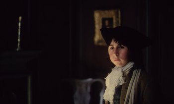 Movie still from “Black Jack” (1979), directed by Ken Loach – A young boy wearing an old - fashioned costume; Close Up shot, Over the shoulder angle