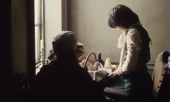 Movie still from “Black Jack” (1979), directed by Ken Loach – A woman is sitting in front of a window and a man is standing next to a window; Medium shot, Over the shoulder angle