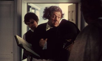 Movie still from “Black Jack” (1979), directed by Ken Loach – A man in a black jacket and a man in a white shirt; Medium shot, Over the shoulder angle