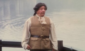 Movie still from “Black Jack” (1979), directed by Ken Loach – An old man wearing a brown vest and a white shirt; Medium shot, Over the shoulder angle
