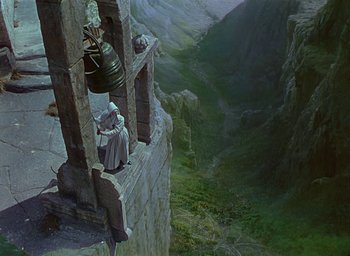 Movie still from “Black Narcissus” (1947), directed by Emeric Pressburger – A painting of two people standing on top of a cliff; Extreme Wide shot, Overhead angle