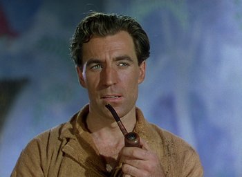 Movie still from “Black Narcissus” (1947), directed by Emeric Pressburger – A person holding a pipe in his mouth; Close Up shot, High angle