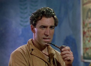 Movie still from “Black Narcissus” (1947), directed by Emeric Pressburger – A person with a pipe in his mouth; Close Up shot, Over the shoulder angle