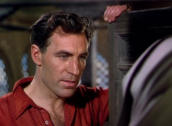 Movie still from “Black Narcissus” (1947), directed by Emeric Pressburger – A person wearing a red shirt; Close Up shot, Over the shoulder angle