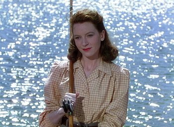 Movie still from “Black Narcissus” (1947), directed by Emeric Pressburger – A woman holding a fishing pole in front of a body of water; Close Up shot, High angle