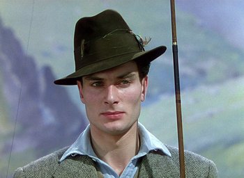 Movie still from “Black Narcissus” (1947), directed by Emeric Pressburger – A man wearing a hat and holding a fishing pole; Close Up shot, Low angle