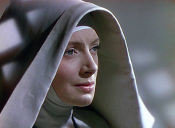 Movie still from “Black Narcissus” (1947), directed by Emeric Pressburger – A woman wearing a nun's habit and a white head scarf; Close Up shot, Low angle