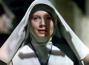 Movie still from “Black Narcissus” (1947), directed by Emeric Pressburger – A woman wearing a nun's outfit with a necklace; Close Up shot, Low angle