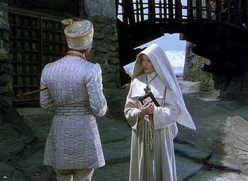 Movie still from “Black Narcissus” (1947), directed by Emeric Pressburger – Two women dressed up in medieval clothing; Wide shot, Low angle