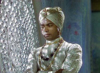 Movie still from “Black Narcissus” (1947), directed by Emeric Pressburger – A man wearing a turban and a white dress; Medium shot, Low angle