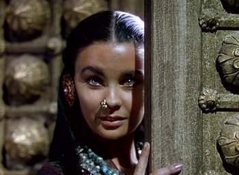 Movie still from “Black Narcissus” (1947), directed by Emeric Pressburger – A woman with a nose ring is posing for a picture; Close Up shot, Over the shoulder angle