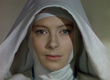 Movie still from “Black Narcissus” (1947), directed by Emeric Pressburger – A woman wearing a nun's head covering; Close Up shot, Overhead angle
