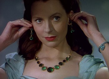 Movie still from “Black Narcissus” (1947), directed by Emeric Pressburger – A woman wearing a necklace and earring set; Close Up shot, Over the shoulder angle