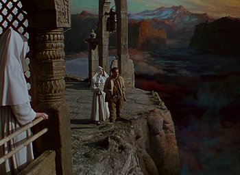 Movie still from “Black Narcissus” (1947), directed by Emeric Pressburger – Two people standing on the edge of a cliff looking out into the sky; Extreme Wide shot, High angle