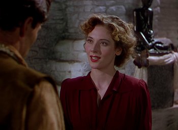 Movie still from “Black Narcissus” (1947), directed by Emeric Pressburger – A woman in a red shirt talking to a man in a brown jacket; Close Up shot, Over the shoulder angle