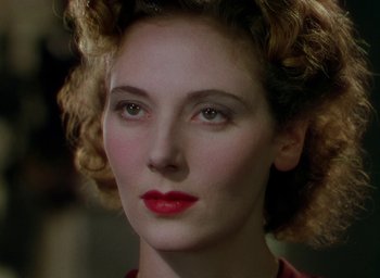 Movie still from “Black Narcissus” (1947), directed by Emeric Pressburger – A person with curly brown hair; Close Up shot, Over the shoulder angle