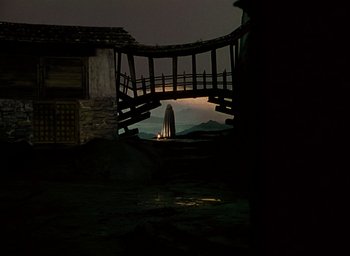 Movie still from “Black Narcissus” (1947), directed by Emeric Pressburger – A view of a building from a bridge at night; Extreme Wide shot, Low angle