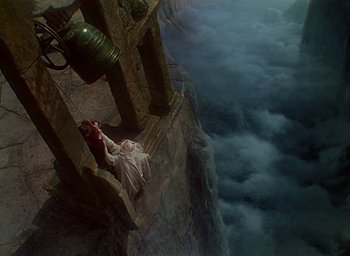Movie still from “Black Narcissus” (1947), directed by Emeric Pressburger – A woman laying on the ground next to a bell; Extreme Wide shot, Overhead angle