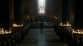 Movie still from “Game of Thrones” (2011), created by D.B. Weiss – A group of people standing in front of a clock tower; Extreme Wide shot, Low angle