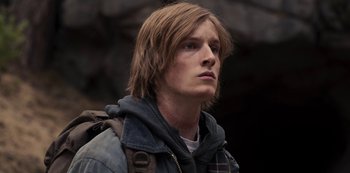 Movie still from “Dark” (2017), created by Baran bo Odar – A man with long brown hair wearing a jacket; Close Up shot, Low angle