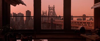 Movie still from “Black Rain” (1989), directed by Ridley Scott – A view of a bridge from a window at dusk; Wide shot, Over the shoulder angle