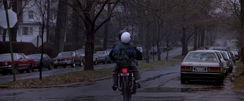 Movie still from “Black Rain” (1989), directed by Ridley Scott – A person riding a motorcycle down a street; Wide shot, Low angle