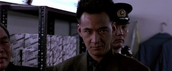 Movie still from “Black Rain” (1989), directed by Ridley Scott – A person wearing a suit and tie; Close Up shot, Low angle